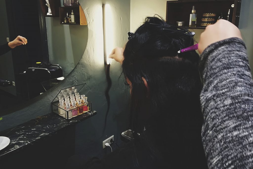 Nyla examining a strand of hair extensions